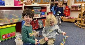 Children playing with wooden train set